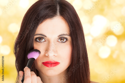 Photo: Woman applying blusher Woman applying blusher