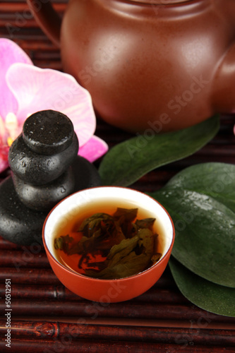 Photo: Chinese tea ceremony on bamboo table close-up Chinese tea ceremony on bamboo table close-up