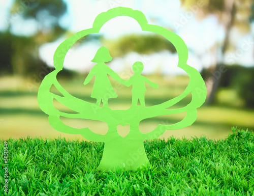 Photo: Green cut out paper tree with people inside, Green cut out paper tree with people inside,