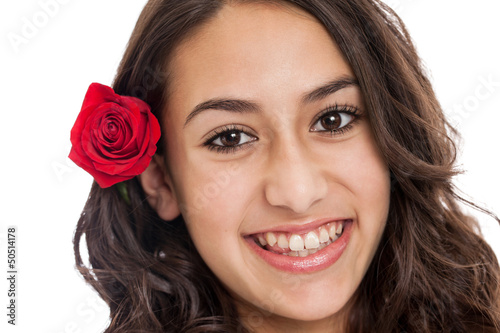 Photo: Cute tween girl with red rose in her hair portrait Cute tween girl with red rose in her hair portrait