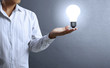 Light bulb, in a hand