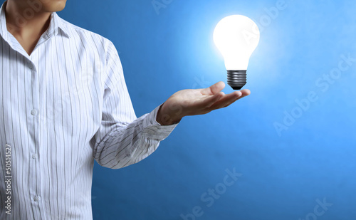 Photo: Light bulb, in a hand Light bulb, in a hand