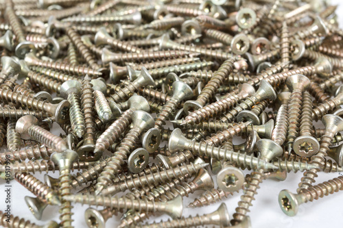 Photo: Closeup pile of screw on white Closeup pile of screw on white
