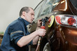 auto mechanic polishing car