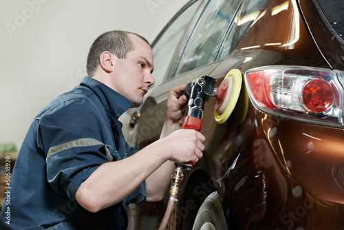 Photo: auto mechanic polishing car auto mechanic polishing car