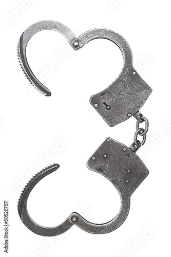 Photo: Metal handcuffs for hands on a white background Metal handcuffs for hands on a white background