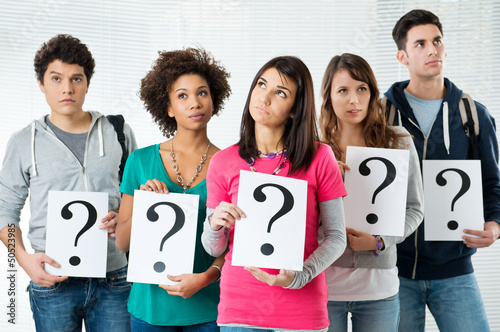 Photo: Students Holding Question Mark Students Holding Question Mark