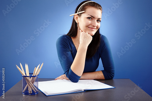 Photo: Young student sitting at her desk Young student sitting at her desk