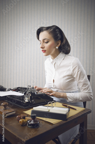 Photo: Woman typing in her office Woman typing in her office