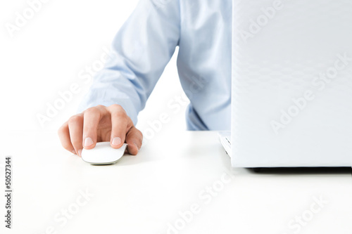 Photo: Close up of young man working on a laptop isolated on white Close up of young man working on a laptop isolated on white