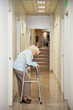 Elderly Woman Standing In Passageway