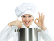 Female chef cook tasting delicious soup and shows ok