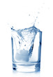 Photo: Ice in glass of water with splash on white background. Ice in glass of water with splash on white background.