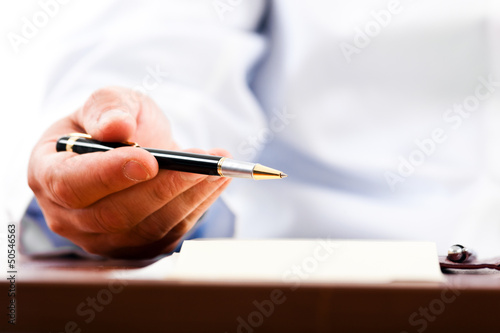 Photo: Closeup shot of a doctor writing a medical recipe Closeup shot of a doctor writing a medical recipe