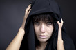 Scary woman with pale face. Covered with black cloth.