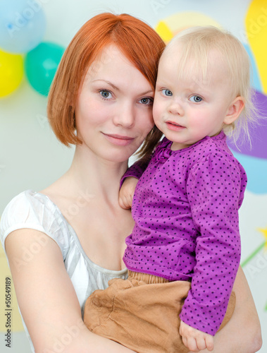Photo: Young mother holding her little daughter Young mother holding her little daughter