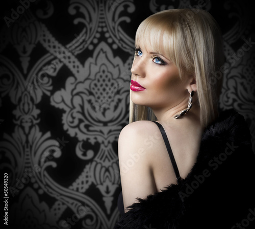 Photo: Portrait of beautiful woman in luxury fur coat Portrait of beautiful woman in luxury fur coat