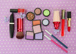Decorative cosmetics on purple background