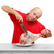 An butcher cutting fresh lamb meat.