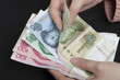 Female's hand holding Chinese banknotes