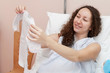 Mom examines baby romper