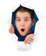 Surprised boy looking through paper hole isolated