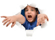 Frightened boy escaping through paper hole isolated
