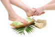 Female feet receiving a massage, isolated on white