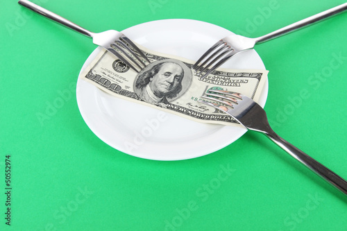 Photo: Money on plate on green background Money on plate on green background