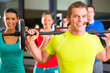 weight training in the gym with dumbbells