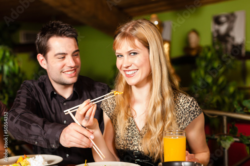 Photo: Young people eating in Thai restaurant Young people eating in Thai restaurant