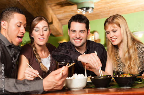 Photo: Young people eating in Thai restaurant Young people eating in Thai restaurant