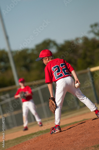 Photo: Little league baseball pitcher looking at batter. Little league baseball pitcher looking at batter.