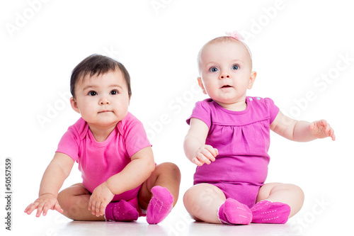 Photo: Funny babies girls sitting beside on floor Funny babies girls sitting beside on floor