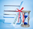 Photo: Diploma and books and hourglass Diploma and books and hourglass