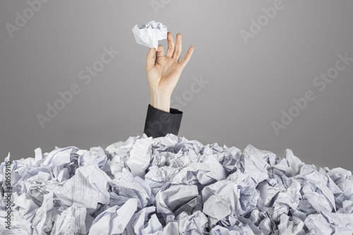 Photo: Person under pile of documents Person under pile of documents