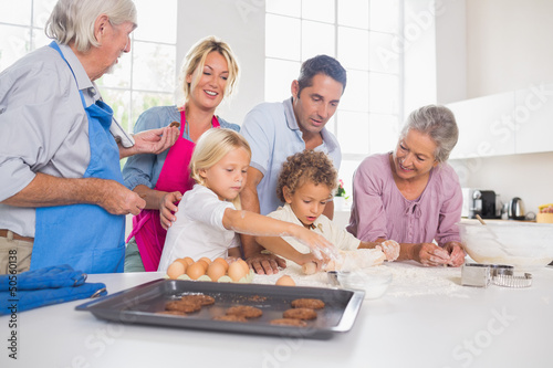 Photo: Family preparing biscuits together Family preparing biscuits together