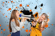 Girl shouting at another covering her ears through megaphone