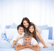 Happy family portrait in bed