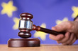 Hand banging gavel on sounding block