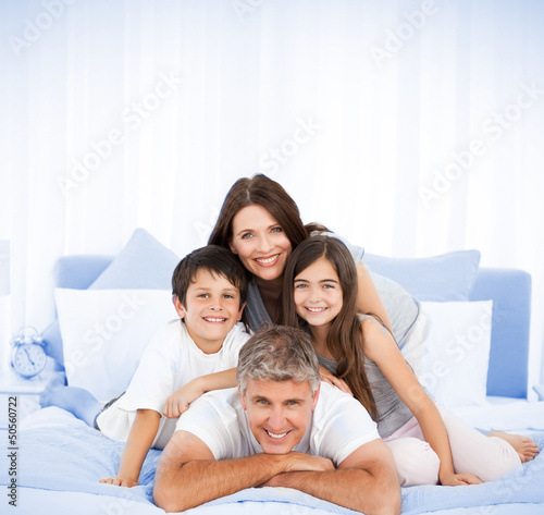 Photo: Happy family portrait in bed Happy family portrait in bed