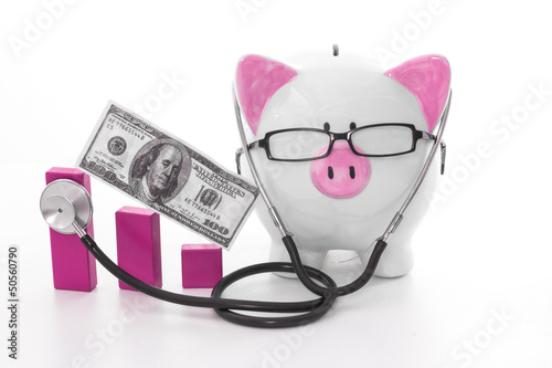 Photo: Pink and white piggy bank wearing glasses and stethoscope Pink and white piggy bank wearing glasses and stethoscope