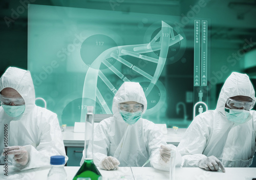 Photo: Scientists working in protective suite with futuristic interface Scientists working in protective suite with futuristic interface