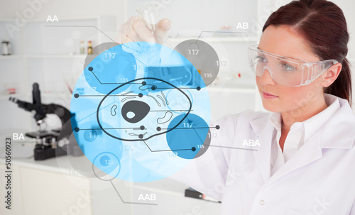 Photo: Chemist examining cell interface Chemist examining cell interface