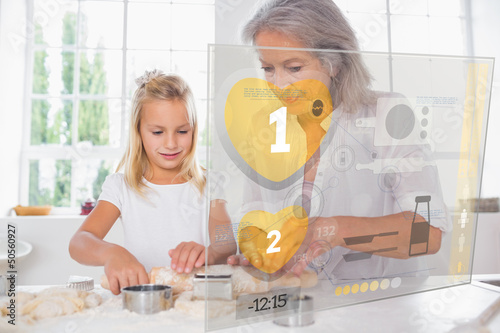 Photo: Grandmother and granddaughter baking with interface Grandmother and granddaughter baking with interface