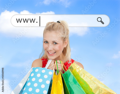 Photo: Happy blonde with her shopping bags under address bar Happy blonde with her shopping bags under address bar