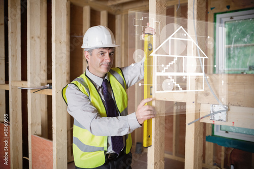 Photo: Architect using spirit level and looking at white hologram inter Architect using spirit level and looking at white hologram inter