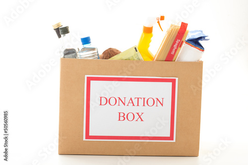 Photo: Cardboard donation box with houseware product and food Cardboard donation box with houseware product and food