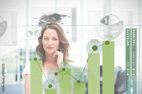Photo: Blonde businesswoman using green chart interface Blonde businesswoman using green chart interface