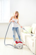 young girl cleaning sofa